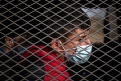 Asylum seeking unaccompanied minors are transported in a U.S. Border Patrol vehicle after they crossed the Rio Grande river into the United States from Mexico on a raft in Penitas, Texas, March 9, 2021.