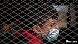 Asylum seeking unaccompanied minors are transported in a U.S. Border Patrol vehicle after they crossed the Rio Grande river into the United States from Mexico on a raft in Penitas, Texas, March 9, 2021.