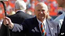 Former Miami Dolphins owner, Wayne Huizenga stands on the field before an NFL football game between the Miami Dolphins and New York Jets, Jan. 1, 2012, in Miami. 