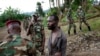 FILE— In this file photo taken November 27, 2012, Congolese M23 rebel fighters detain a man they suspect to be an FDLR (Force Democratique de Liberation du Rwanda) rebel returning from an incursion into Rwanda Near Kibumba, north of Goma.