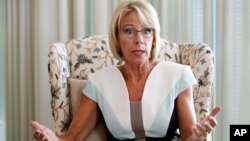 Education Secretary Betsy DeVos is interviewed in her office at the Education Department in Washington, Aug. 9, 2017. 