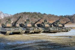 FILE - M1-A2SEP Abrams tanks participating in a platoon qualifying exercise near the DMZ. (Photo: VOA / Steve Herman)