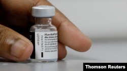 FILE PHOTO: A medical worker prepares to dilute a vial of Pfizer-BioNTech vaccine at a coronavirus disease (COVID-19) vaccination center in Singapore