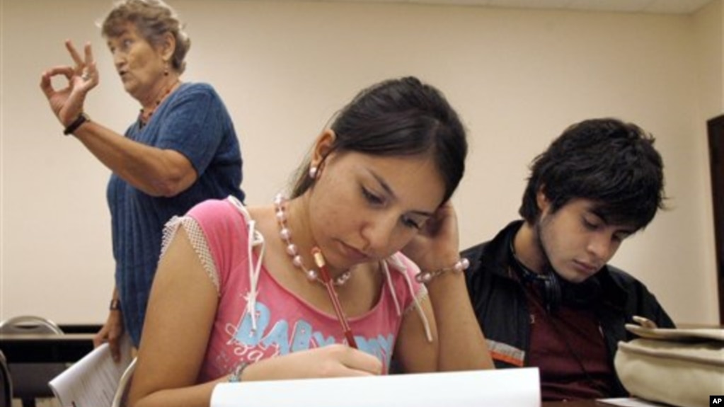 FILE - Students at the University of Texas-Southmost College work on a writing assignment in an English as a Second Language class in 2006. (AP Photo/Brad Doherty)