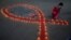 FILE - A girl lights earthen lamps during an HIV/AIDS awareness campaign on the occasion of World AIDS Day in Kolkata, India, December 1, 2021.