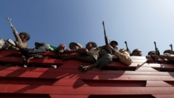 Members of Amhara region militias ride on their truck as they head to the mission to face the Tigray People's Liberation Front (TPLF), in Sanja, Amhara region near a border with Tigray, November 9, 2020.