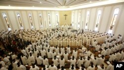 FILE - Prelates attend a mass celebrated in the Legion of Christ main headquarters, the Ateneo Pontificio Regina Apostolorum, in Rome, Feb. 25, 2014.