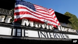 "The Interview," the comedy starring Seth Rogen and James Franco, is listed under an American flag on the marquee of the Cinefamily at Silent Movie Theater in Los Angeles, Dec. 25, 2014.