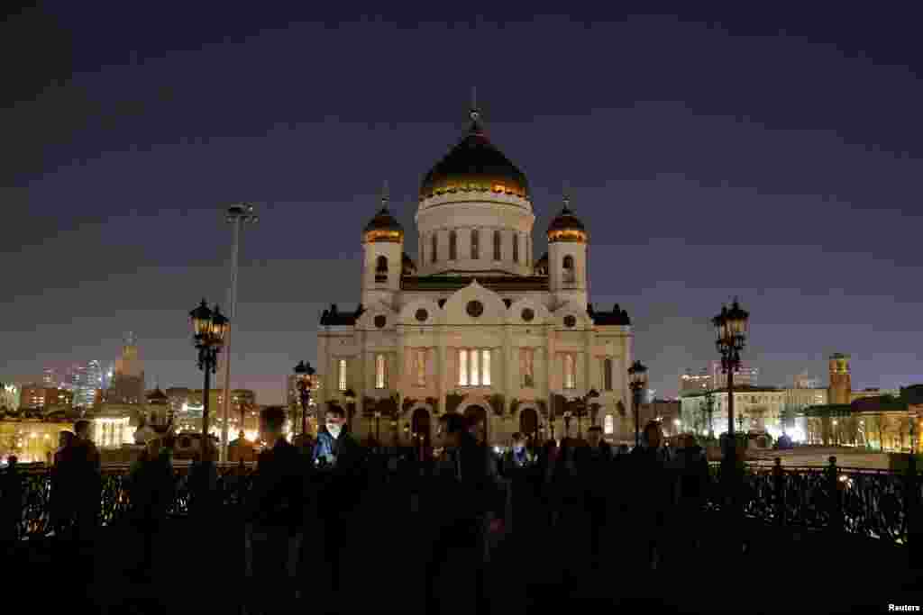 The Cathedral of Christ the Saviour is seen after the lights are switched off for Earth Hour in Moscow, March 30, 2019.