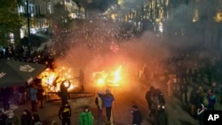 Protesters rally outside the parliament building in Tbilisi, Georgia, following the Georgian government's decision to suspend negotiations to join the European Union, Nov. 29, 2024.