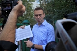 FILE - Russian opposition leader Alexei Navalny speaks with journalists in Moscow, Russia, Sept. 8, 2019.
