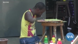 Ivorian Painter With No Arms or Legs Makes Art -- and A Living