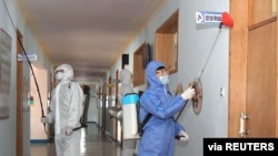 Volunteers carry out disinfection work during an anti-virus campaign in Pyongyang, North Korea in this image released by North Korea's Korean Central News Agency (KCNA) on March 4, 2020.