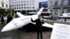 FILE - An inflatable representing a private jet is displayed by activists outside the European Parliament in Brussels, April 11, 2024, urging lawmakers to impose more taxes on Europe’s wealthiest.