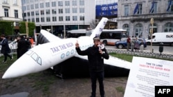 FILE - An inflatable representing a private jet is displayed by activists outside the European Parliament in Brussels, April 11, 2024, urging lawmakers to impose more taxes on Europe’s wealthiest.