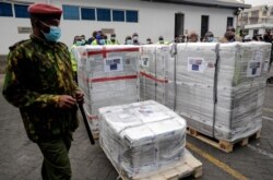 FILE - In this  Aug.6. 2021, photo, a Kenyan soldier guards a consignment of 182,000 AstraZeneca vaccine doses received from the Greek government via the COVAX facility, at Kenya Jomo Kenyatta airport in Nairobi.