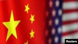 FILE - Chinese and U.S. flags are seen in this illustration created on Jan. 30, 2023.