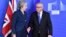 European Commission President Jean-Claude Juncker, right, prepares to shake hands with British Prime Minister Theresa May, left, before their meeting at the European Commission headquarters in Brussels, Belgium, Feb. 7, 2019. 
