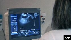 Chinese gymnast Chen Yibing performs on the rings during the Artistic Gymnastic men's team final, July 30, 2012.