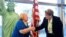 New US citizen Tamam Shanazarian, left, shakes hands with Nancy Alby, field director of USCIS Los Angeles, during a naturalization ceremony ahead of World Refugee Day by the US Citizenship and Immigration Services on June 17, 2021 in Los Angeles.