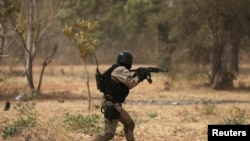 A soldier from Burkina Faso participates in a simulated raid during the U.S. sponsored Flintlock exercises in Ouagadougou, Burkina Faso February 24, 2019.