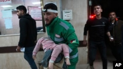 FILE — Palestinians wounded in the Israeli bombardment of the Gaza Strip are brought to Al Aqsa hospital in Deir al Balah, February 23, 2024. 