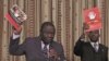 Zimbabwe Prime Minister and Movement For Democratic Change (MDC) leader Morgan Tsvangirai (L) and National Organising Secretary Nelson Chamisa present a booklet at the launch of Conditions for a Sustainable Election in Zimbabwe (COSEZ) in Harare, March 8