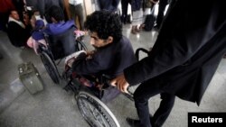 Wounded Houthi fighters wait at Sana'a airport during his evacuation from Yemen, Dec. 3, 2018. 