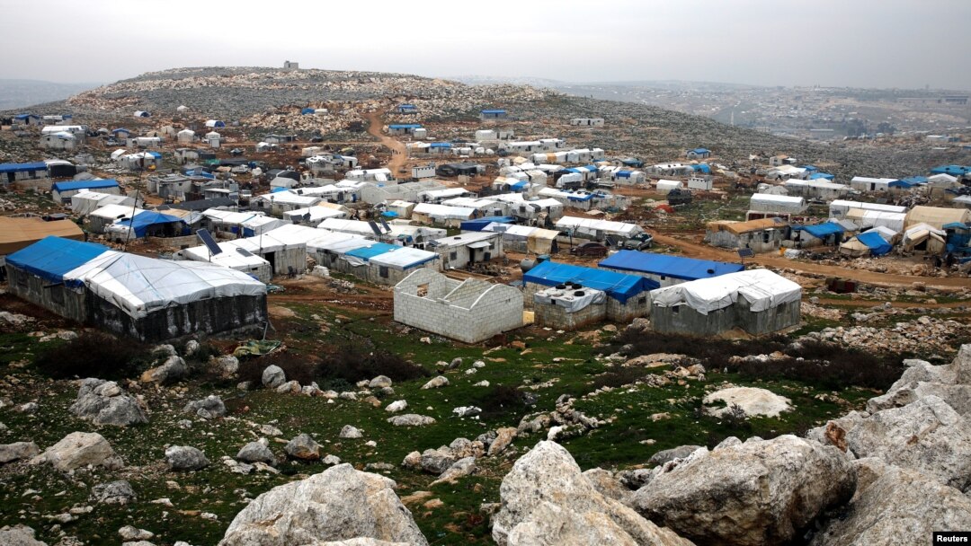 FILE - Makeshift shelters of internally displaced Syrians are seen from a hill top in Sarmada, Idlib province, Syria, Feb. 28, 2020.