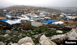Makeshift shelters of internally displaced Syrians are seen from a hill top as part of an IDP camp located in Sarmada, Idlib province, Syria, Feb. 28, 2020. R