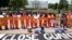 Activists wearing orange jumpsuits mark the 100th day of prisoners' hunger strike at Guantanamo Bay during a protest in front of the White House in Washington May 17, 2013. 