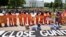 Activists wearing orange jumpsuits mark the 100th day of prisoners' hunger strike at Guantanamo Bay during a protest in front of the White House in Washington May 17, 2013. 