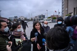 Human Rights Watch Turkey director Emma Sinclair-Webb, center, talks to the press on Dec. 18, 2020 in Istanbul after a hearing in the trial of jailed Turkish philanthropist Osman Kavala, on charges connected with a failed coup in 2016.