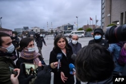 Human Rights Watch Turkey director Emma Sinclair-Webb, center, talks to the press on Dec. 18, 2020 in Istanbul after a hearing in the trial of jailed Turkish philanthropist Osman Kavala, on charges connected with a failed coup in 2016.