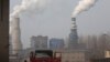 In this Dec. 30, 2016 photo, a truck leaves a sprawling complex that is a part of the Jiujiang steel and rolling mills in Qianan in northern China's Hebei province.