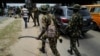 Nigerian security forces patrol as anti-government demonstrators march in the streets to protest bad governance and economic hardship, in Lagos, Nigeria, on Aug. 3, 2024.