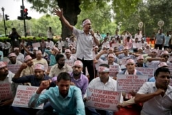 FILE - Activists shout slogans during a protest in front of Assam House against the final draft of the National Register of Citizens (NRC) in the state of Assam, in New Delhi, Aug. 4, 2018.