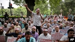 FILE - Activists shout slogans during a protest in front of Assam House against the final draft of the National Register of Citizens (NRC) in the northeastern state of Assam, in New Delhi, Aug. 4, 2018. 