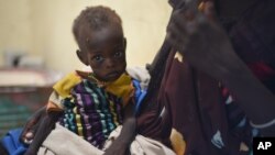 Nyagoah Taka Gatluak, a severely malnourished 1-year-old child, sits on her mother's lap in the Doctors Without Borders clinic in Leer, South Sudan, Dec. 15, 2015 — the two-year anniversary of the beginning of the country's civil war. 