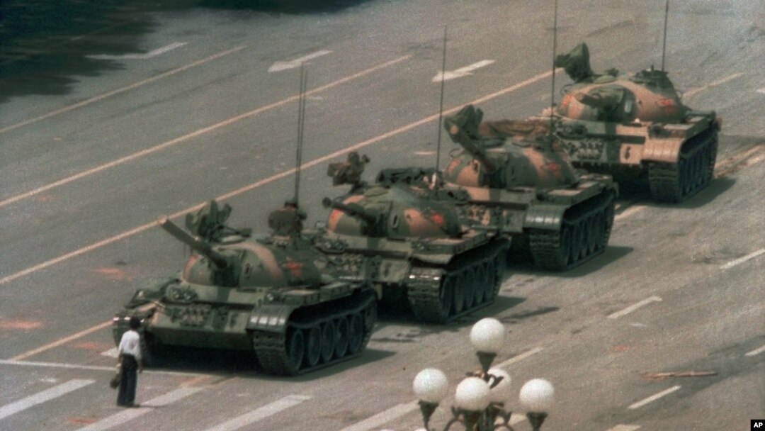 FILE - A Chinese man stands alone to block a line of tanks heading east on Beijing's Cangan Blvd. in Tiananmen Square in Beijing on June 5, 1989. 
