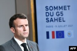 FILE - French President Macron reacts during a joint press conference with Niger's president in Paris, on July 9, 2021, following a video summit with leaders of G5 Sahel countries.