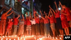 People take part in a noise campaign on the street after calls for protest against the military coup emerged on social media, in Yangon, Feb. 5, 2021. 