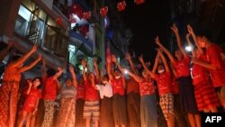 People take part in a noise campaign on the street after calls for protest against the military coup emerged on social media, in Yangon, Feb. 5, 2021. 